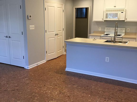 Kitchen with washer/dryer and water heater in closet.