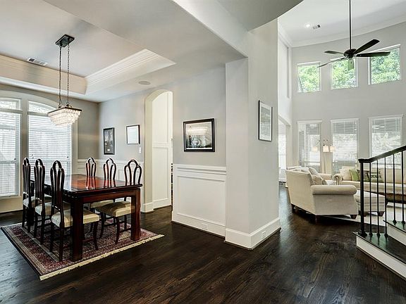 From family dinners to formal entertaining, this dining room can rise to any occasion. The designer chandelier is centered in the tray ceiling which is accented by crown molding. The wainscoting that surrounds the room is topped by chair molding.