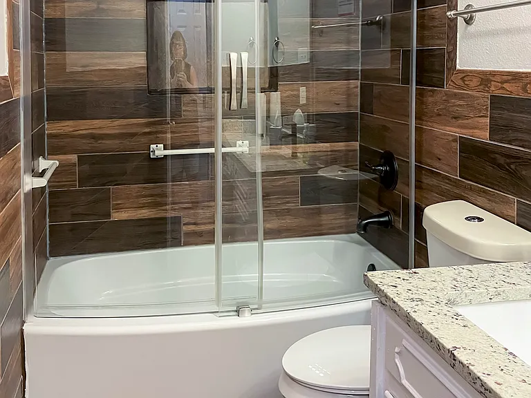 Main Floor Bathroom with Tub-Shower Combo, Vanity with Granite Countertop, Toilet