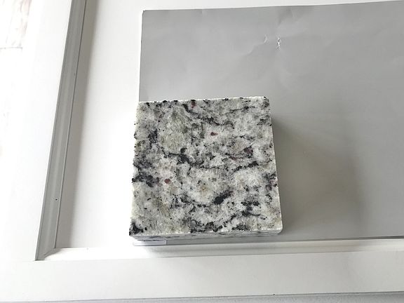 Crisp white cabinets in kitchen are enhanced with beautiful granite and stainless steel appliances.