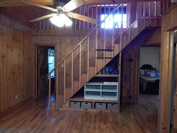 Part of living room and stairs to loft