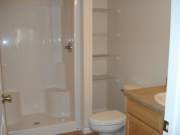 Guest bath with built-in shelving for linens