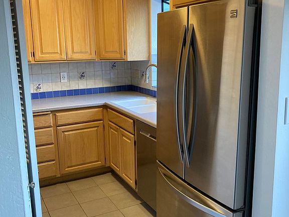 Kitchen with all stainless steel appliances and brand new dishwasher.
