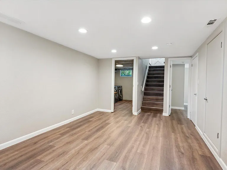2nd Living Space in Basement Features Luxury Vinyl Tile Throughout for Easy Maintenance