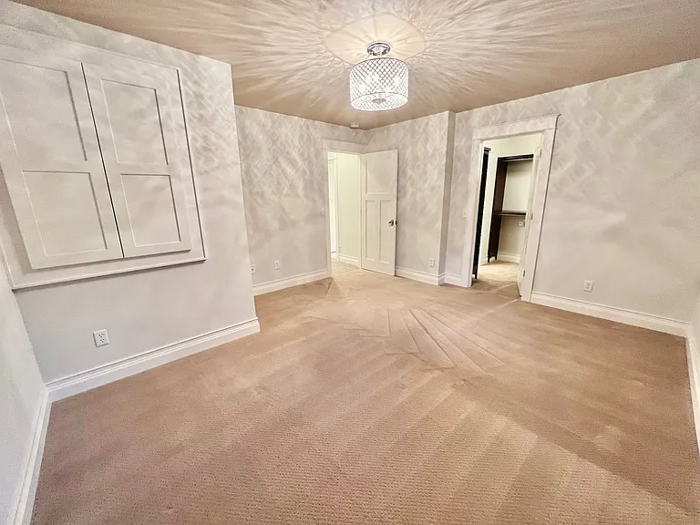 Upper level features a main bedroom suite with spacious walk-in closet, custom built-ins