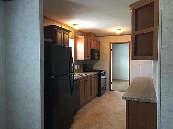 Kitchen with all new, sleek, black appliances: range, built-