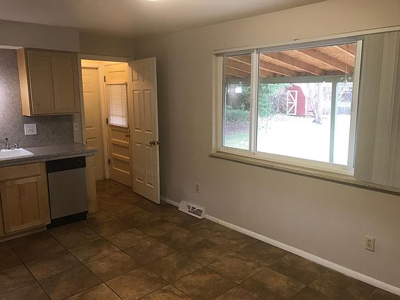 Kitchen with picture window overlooking backyard