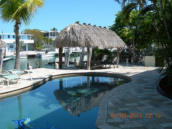 Salt water heated pool with Tiki Hut.
