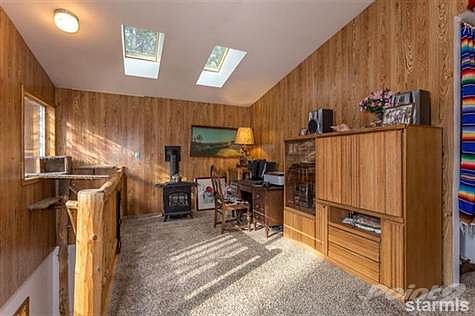 Other side of large family room showing office area w/fireplace