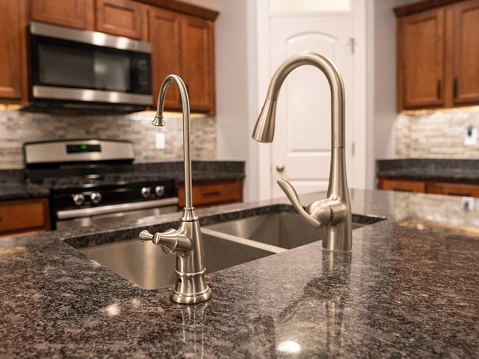 On the left, reverse osmosis faucet. The reverse osmosis water also runs to the refrigerator.