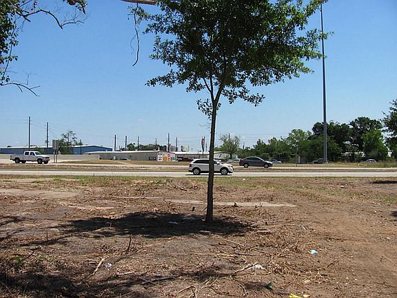 This property is located between two streets.  The Bypass feeder and Briar Meadow.  This is a view of the back of the property on Briar Meadow. You can access the property from both streets.