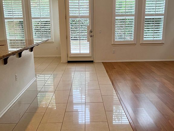 Walkway between kitchen and family room with breakfast nook
