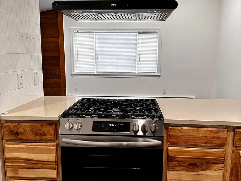 Brand new hood vent, range and solid surface countertops.