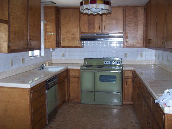 lots of kitchen cupboards, tiffany light in kitchen