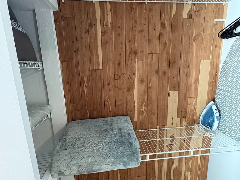 Organized closet space with wire shelving, hanging rod, and room for folded items or stored essentials.