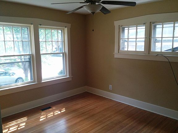 Lovely Living Room with plenty of natural light, unique window trim, and hardwood floors.