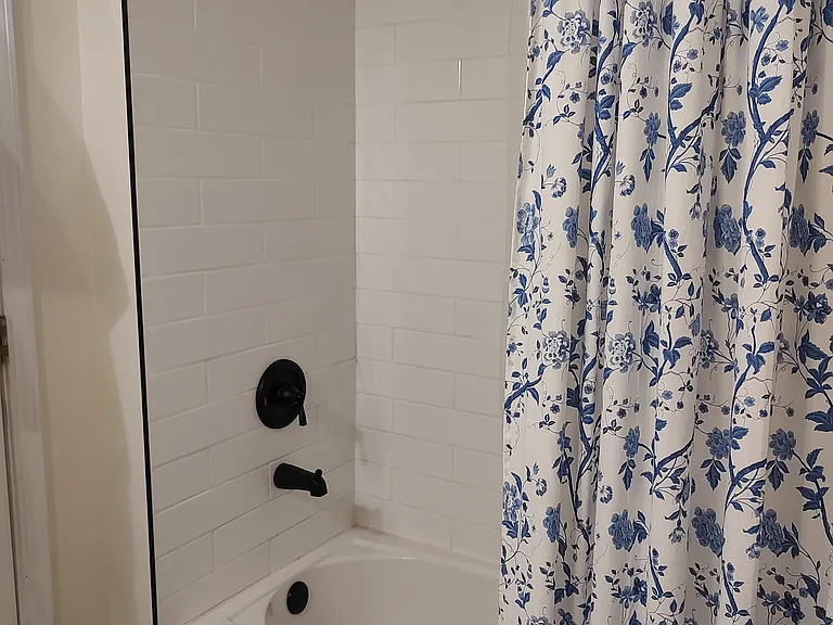 Hall Bathroom - Alternate view. New tub, toilet, white subway tile and black fixtures all add to the modern feel in a historic home.