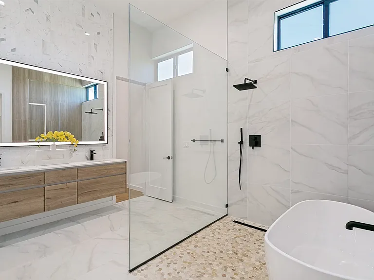 Primary bathroom with large shower/bath area. Large walking closet and 2nd utility room attached.