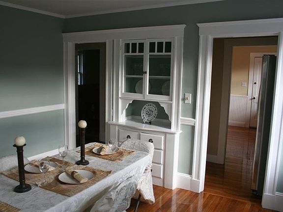 It's all about atmosphere in your dining room with built-in cabinet, chair rail, and dimmer switch