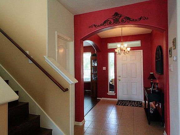 SPACIOUS FOYER WITH HARDWOOD STAIRCASE