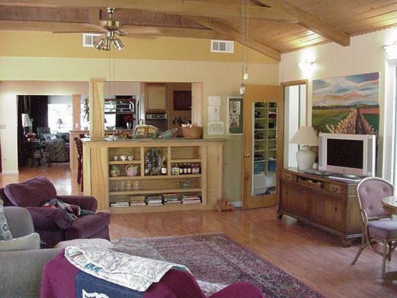 Huge beamed ceiling family room with backyard views and abundant light