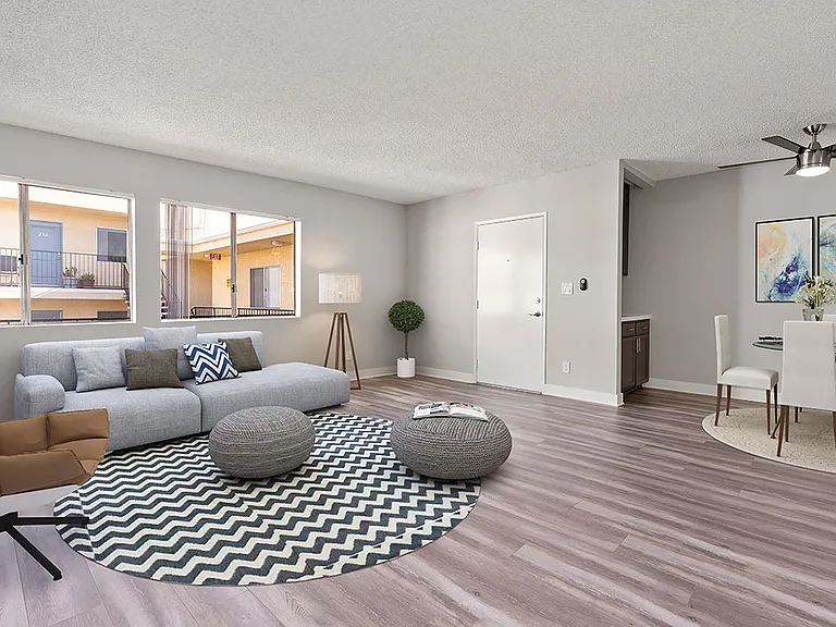 Living room with hardwood floor and view of dining area.