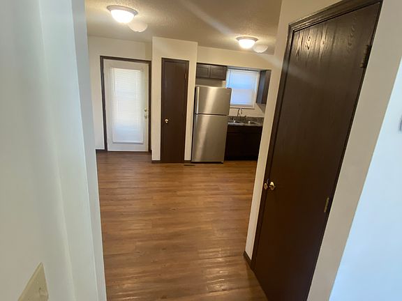 This is the view from the living room into the kitchen. The door to the right is the 1/2 bath and you can see the door to the rear patio by the pantry.