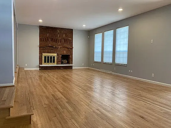 Large great room anchored by a stunning brick fireplace_perfect for entertaining or relaxing evenings at home.