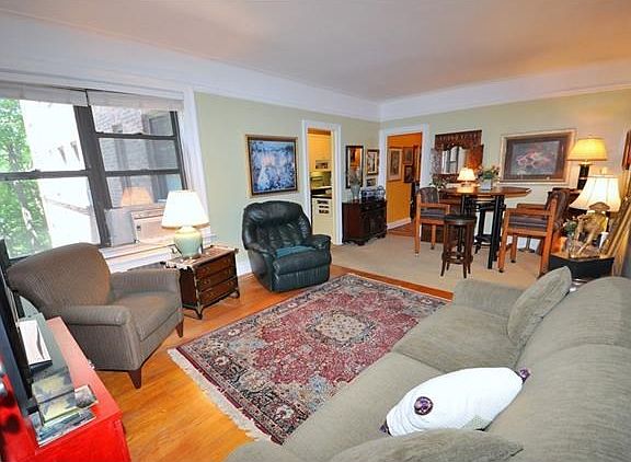 The large living room overlooks Garth Woods and has a cove ceiling, picture molding and hardwood floors.  The living room is 21'-8" x 12'-6"