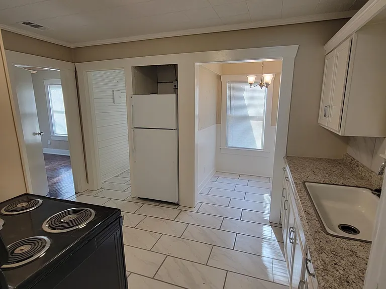 View of Kitchen from Living room, refrigerator included with house