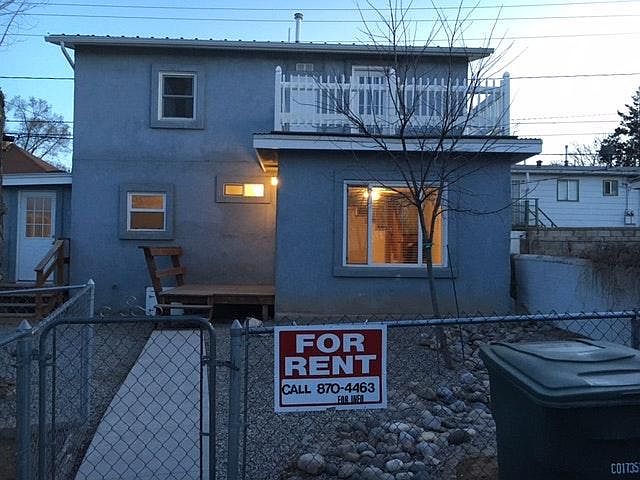 View from parking of fenced yard /home