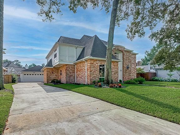 Detached garaged with a wrought iron breezeway gate