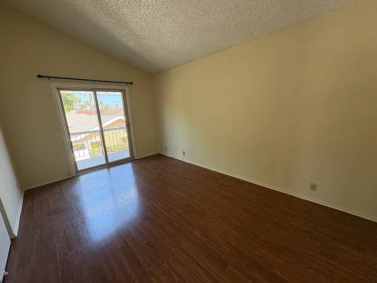 Huge bedroom with cathedral ceiling and slider to private balcony
