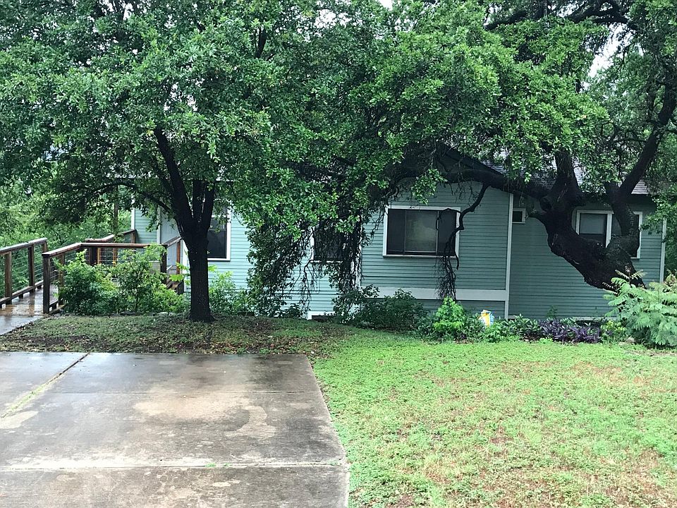 Upper-level entrance with oak filled yard