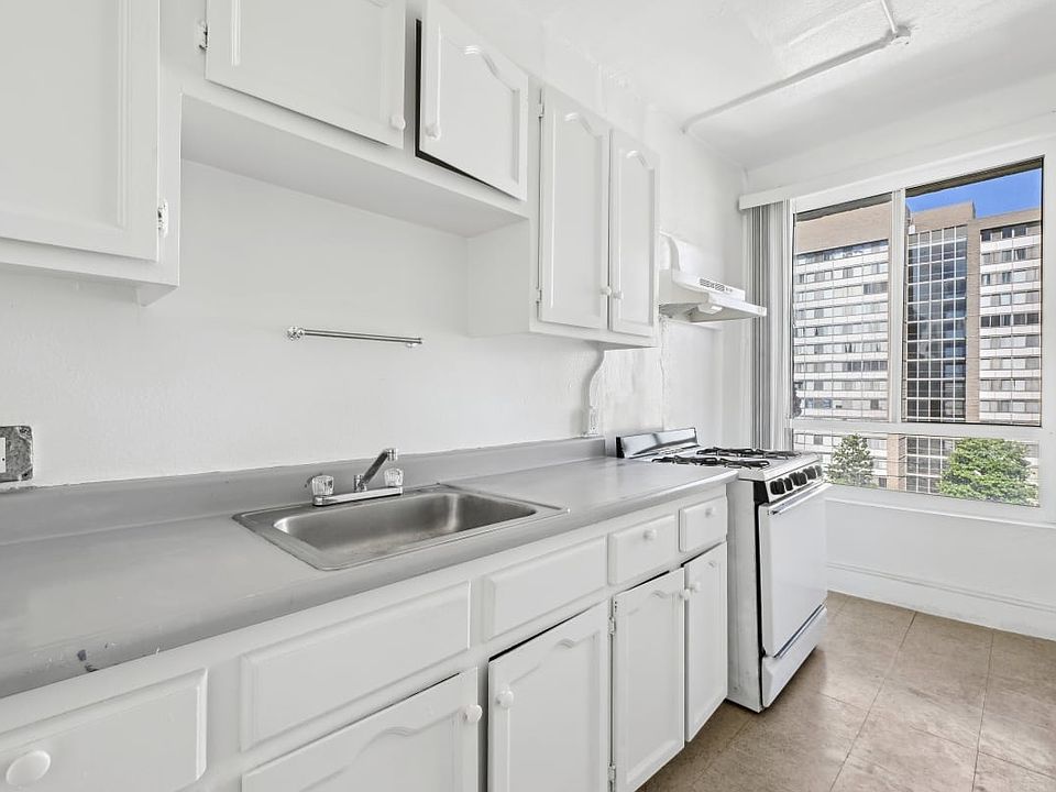 Union a kitchen with white cabinetry and a window