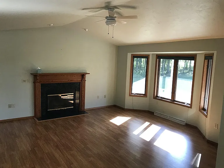Spacious living room with French windows and gas fireplace.