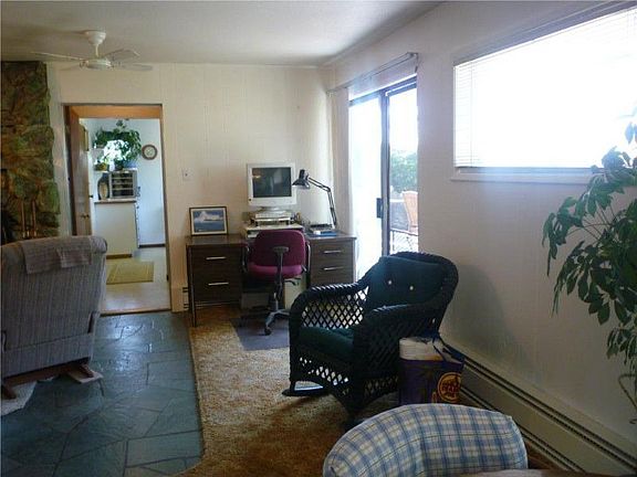 The other side of the open concept living area-you can see part of the big rock fireplace in the sit