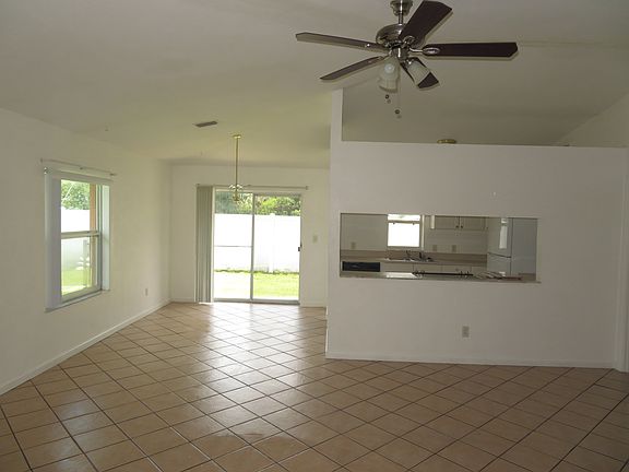 Family Room w/ Vaulted Ceiling and Designer Ceiling Fan