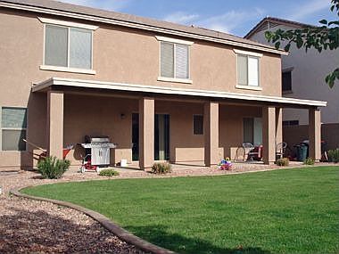 Large landscaped backyard with over extended patio.