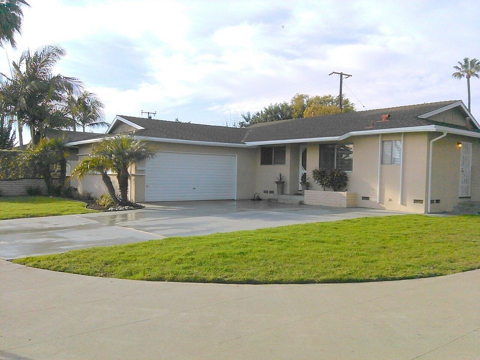 Large corner front yard with oversized driveway, two-car gar