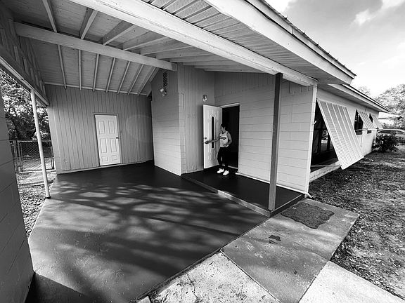 Single carport with storage room and laundry room.