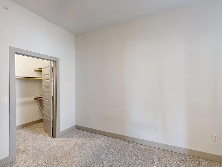 Spacious apartment Bedroom with Carpet Floor.