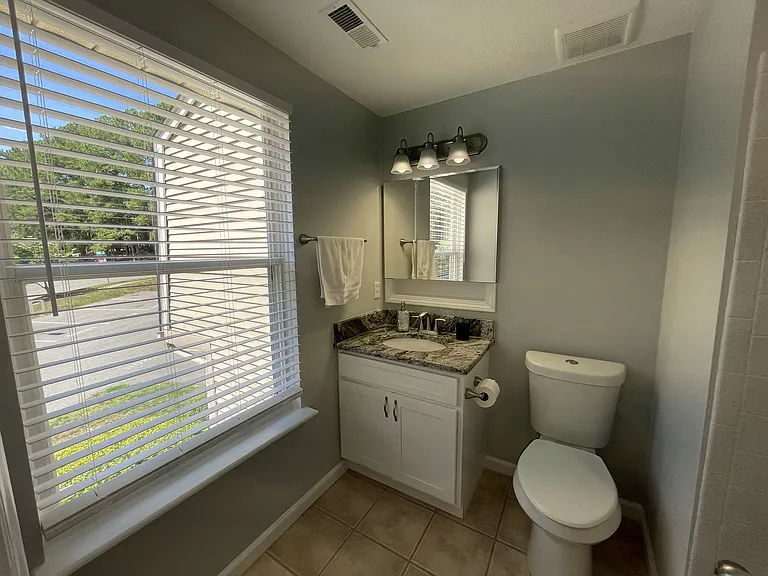 En suite bathroom with high powered exhaust fan/excellent humidity removal and walk-in shower to right.