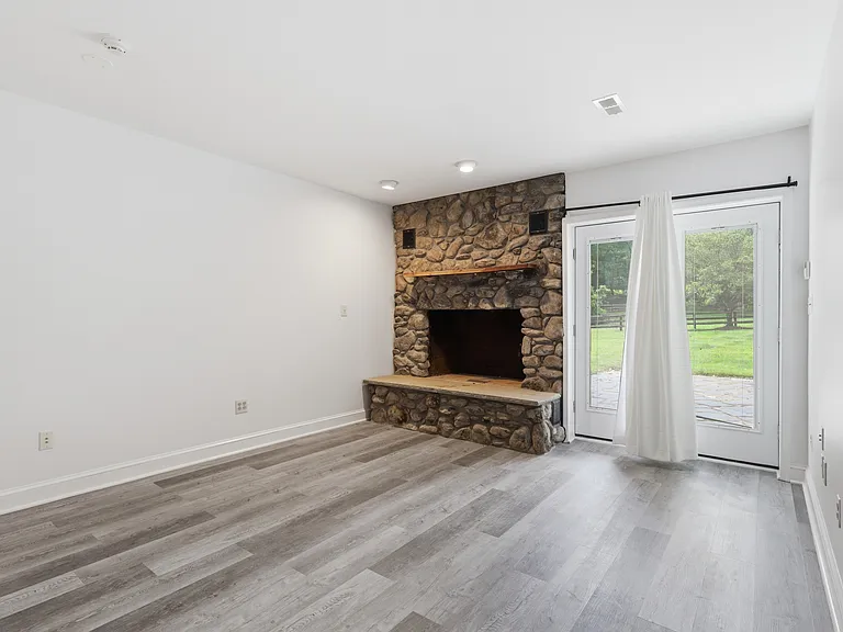 Lower level family room with stone fireplace.
