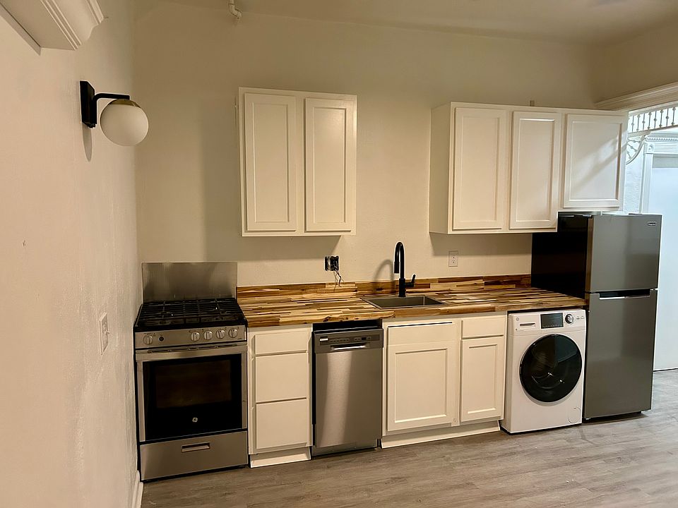 Modern stainless appliances, gorgeous butcher block countertops, shaker style kitchen cabinets.