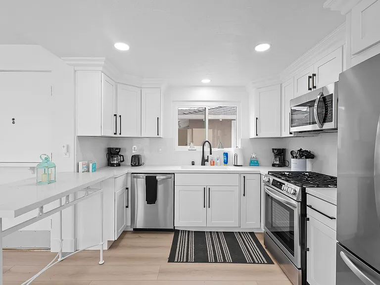 Fully equipped kitchen with dishwasher, range, microwave, and fridge