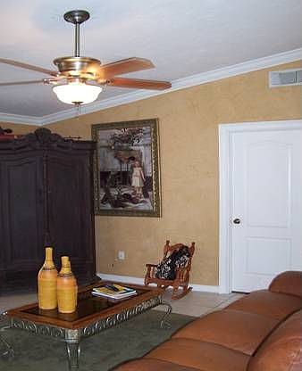 Spacious living room, with textured walls, tile floor 