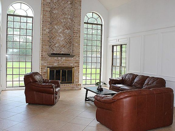 A spacious family room with round arch windows to allow in natural light