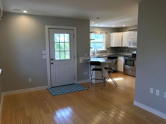 Entry door with seating at kitchen counter
