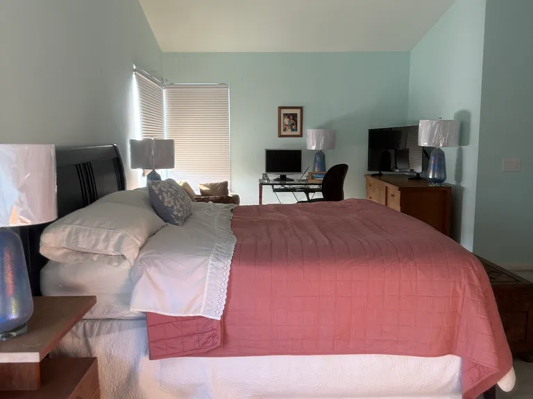 Huge primary bedroom with room for a king bedroom set, sitting area and office space with room to spare. It features a 2 large walk in closets.